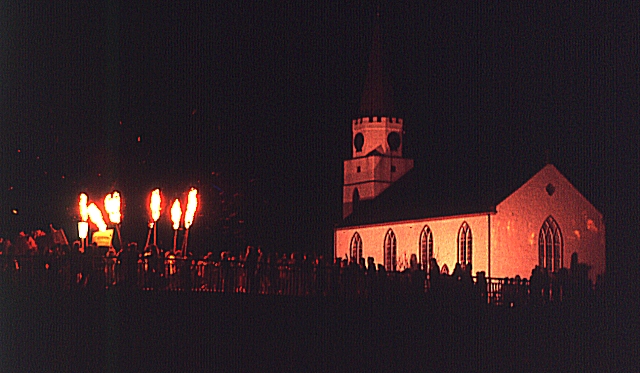 Comrie Flambeaux Procession Comrie celebrates the New Year with a torchlight procession on Hogmanay. This view shows the procession crossing the…