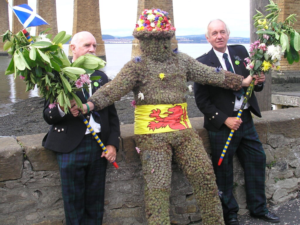 John Nicol, South Queensferry's current Burry Man, takes a rest in full regalia supported by his two attendants. Date: 10 August 2007 Taken: Michael…